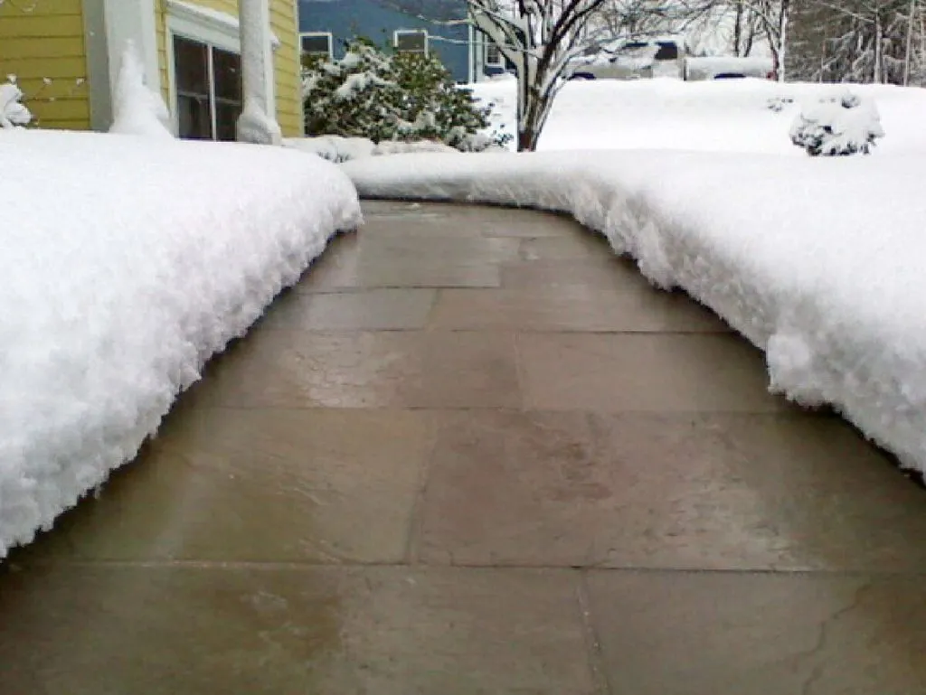 A perfectly clear, de-iced and freshly melted sidewalk.  