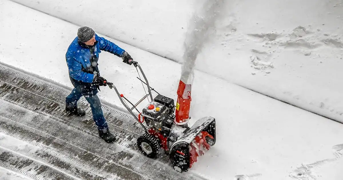 Top down view of a man running a snow blower